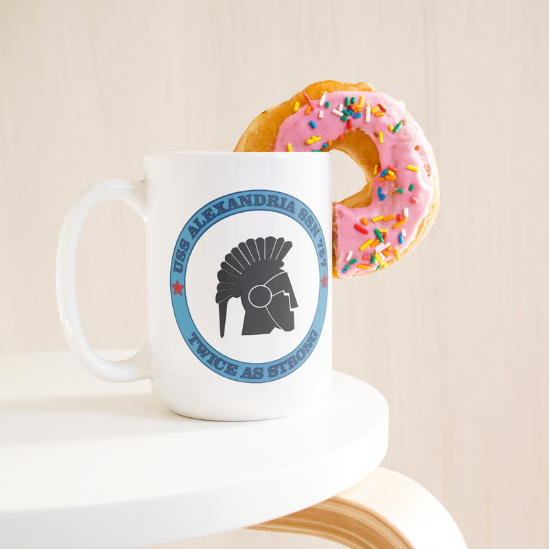 USS_ALexandria_FRG_15oz_Mug_15ozWhiteMugLifetsyleDonutLH_Mockup.png_15831460