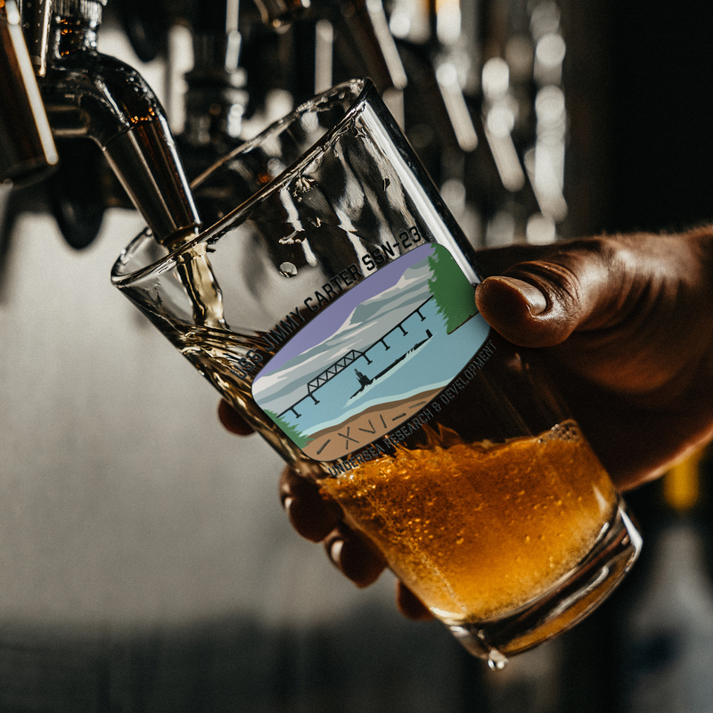 USS_Jimmy_Carter_FRG_Pint_Glass_Pint_Glass_Dark_Lifestyle_Mockup.png_15724148